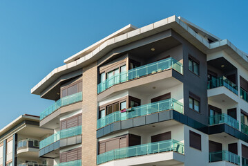 Image of the exterior of a residential building against a blue sky.