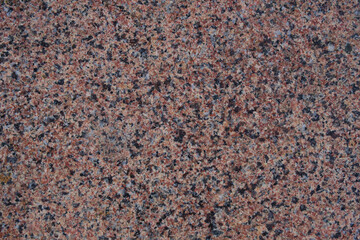 Texture and background red granite rock volcanic origin.