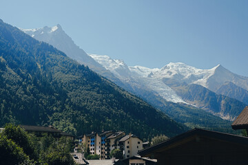 View of the city centre of Chamonix, famous ski resort located in Haute-Savoie, France. Snowy Mont Blanc massif at the background. 