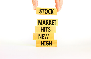 Stock market hits new high symbol. Concept words Stock market hits new high on wooden blocks on a beautiful white background. Businessman hand. Business stock market hits new high concept. Copy space