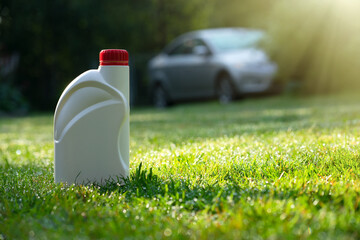 White plastic canister with engine oil. A clean label for the text on the bottle with the vehicle....