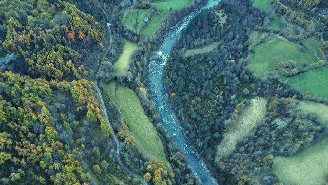 Aerial view of rocky river flowing in countryside on autumn day
