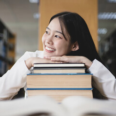 Asian female college students are reading and studying in the library, Learning in the library Concept..