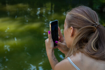 Beautiful blonde girl in a white top and blue skirt