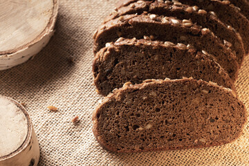 pieces of sliced dark-colored bread on a fabric basis