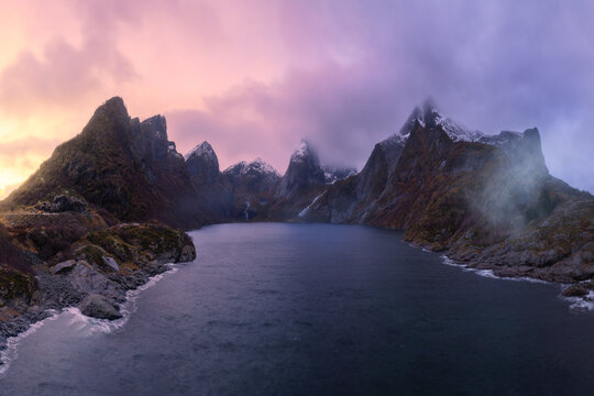 Picturesque fjord with rocky mountains under twilight sky