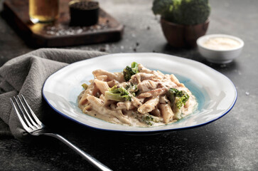 creamy penne chicken broccoli pasta served in a dish side view of fastfood