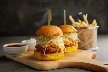 crunchy chicken slider sandwich burger with fries isolated on cutting board side view of fastfood