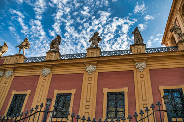 Baroque facade of the historic Palace of San Telmo with ornate sculptures and columns, Seville, Spain.