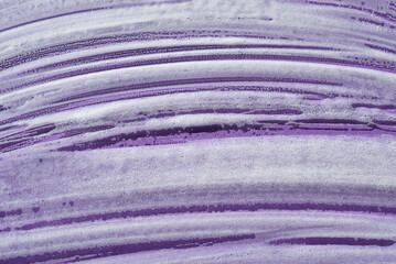 Foam swatch on a violet background. Soapy liquid texture with bubbles. Natural sunshine and...