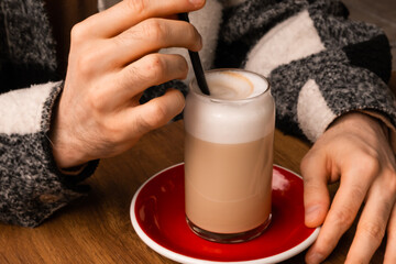 Autumn coffee and desserts close-up. Coffee break outside. Autumn drinks and mood. Flavored coffee. Bright dessert. Eclair. Coffee in male and female hands.