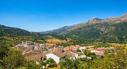 Fototapeta na wymiar Landscape of a small town in the Sierra de Málaga, Andalusia. Scenery of a small city surrounded by mountains. Spain, Europe