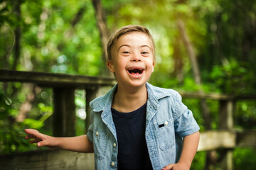 Portrait of a little boy with down syndrome while playing in a park