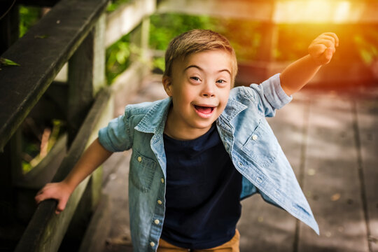 Portrait of a little boy with down syndrome while playing in a park