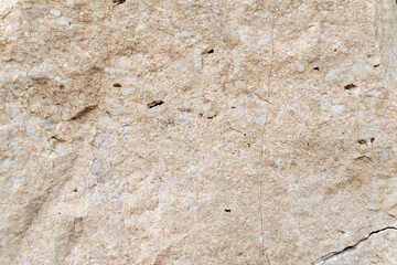 Beige stone wall background. The texture of the stone.