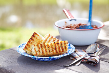 Close-up of savory cornbread in plate on outdoor table