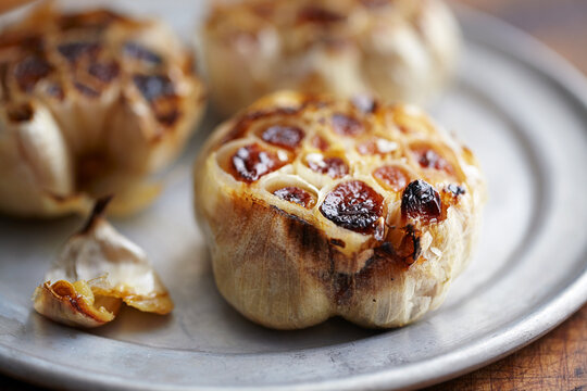 Close-up of roasted garlic in plate on table