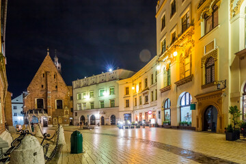 Krakow city in the evening in Poland, Main Square in the Old Town, illuminated St. Mary Church and Cloth Hall (Sukiennice).