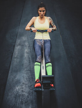 High angle view of athlete using rowing machine in gym