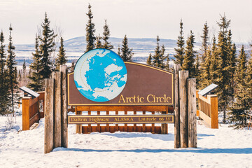 Dalton highway with Arctic Circle sign during winter