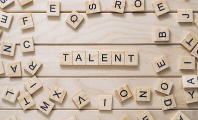 Word Talent and scattered cubes on wooden background