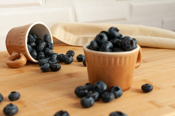 Fresh blueberries in terracotta cups. Coffee cups. Selective focus.