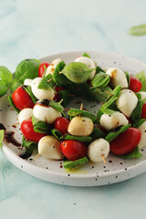 A plate with Italian salad caprese canape