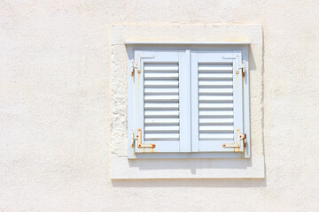Fototapeta na wymiar Traditional Mediterranean window in white on white background.