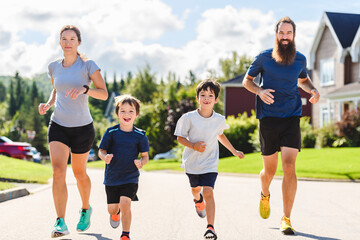 Family exercising and jogging together outdoor on summer season