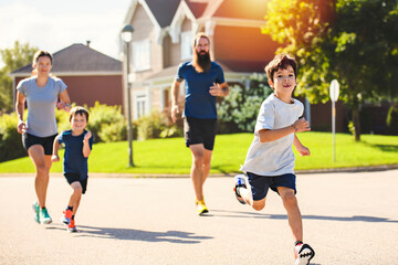 Fototapeta premium Family exercising and jogging together outdoor on summer season