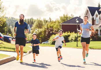 Family exercising and jogging together outdoor on summer season