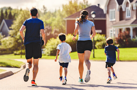 Family exercising and jogging together outdoor on summer season