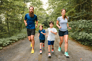 Fototapeta premium Family exercising and jogging together at an outdoor park