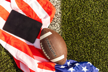 american football ball and tablet, american flag