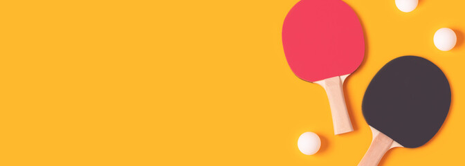 Banner with tennis rackets and white balls on a yellow background. Ping pong creative concept with place for text.