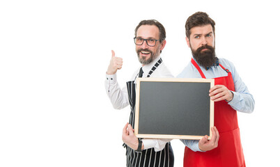 Bartender with blackboard advertisement. Hipster bartender show blackboard copy space. Hiring restaurant staff. Men bearded informing happy hours. Men bearded bartender in apron hold blank chalkboard
