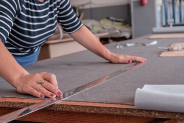 The cutter marks the fabric for cutting in the sewing workshop