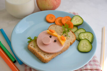 Sandwich with sausage, cucumber in a plate