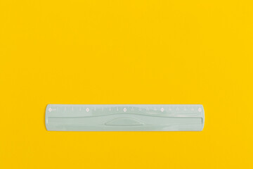 School black ruler on yellow background. Top view with copy space. Flat lay. Back to school concept.