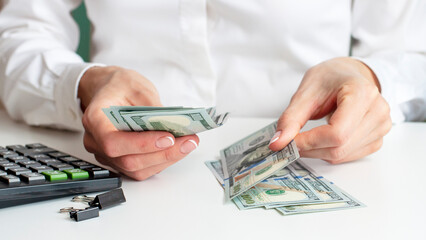 savings, finances, economy concept - close up of woman with calculator counting money and making notes at home.