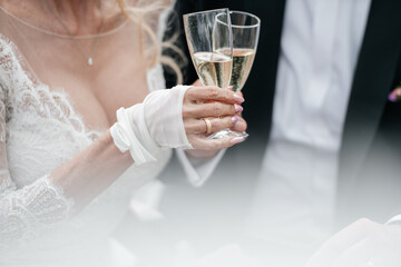 Hands of bride and groom on wedding bouquet. Marriage concept