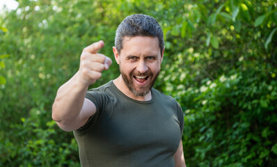 happy man pointing finger. guy pointing finger. adult man pointing finger outdoor