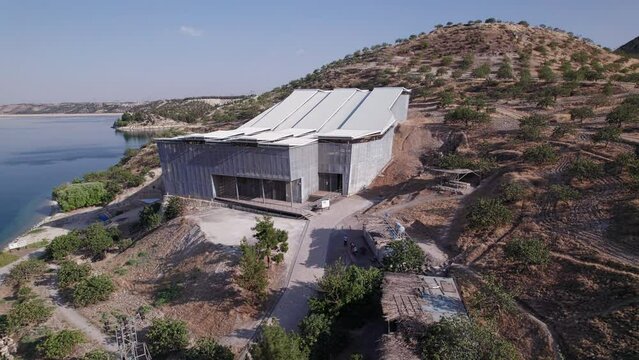 Aerial view Zeugma archeological excavation site, Birecik dam and water reservoir on Euphrates river. Belkis, Gaziantep province, Turkiye