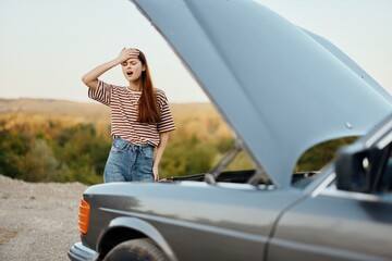 Woman is sad and angry about car breakdown on road trip alone and crying