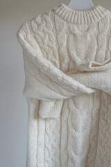 Children's warm white wool sweater isolated on white background