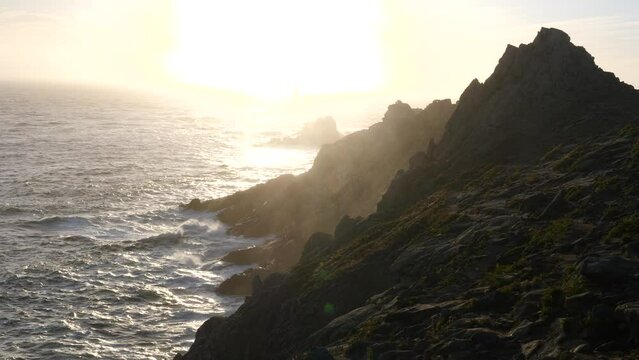 The lighthouse "la Vieille" and the "Pointe du Raz", a famous cape in the west of France during sunset.