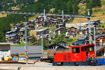 Red train in Zermatt train station, Switzerland, Europe