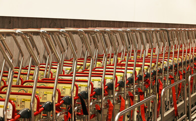 Detail of a row of supermarket karts tidy put together