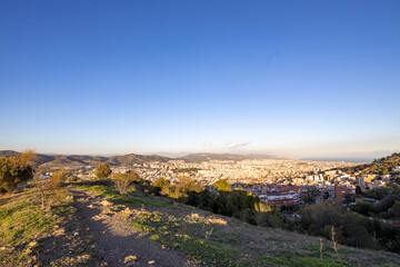 Fototapeta na wymiar Barcelona skyline at sunny day. City landscape view from the mountain.