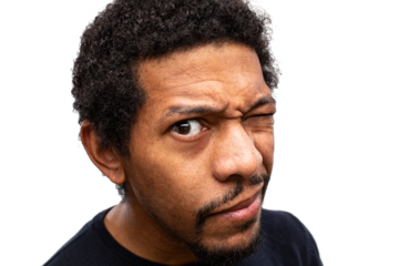 Young African boy peeking into the room with a funny grimace